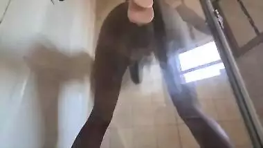 Indian slut fucking her pussy with a suction cup dildo that's stuck against glass door